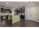 Modern kitchen with dark cabinetry, stainless steel appliances, and a central island with granite countertops at 207 Cherokee Reserve Cir, Canton, GA 30115