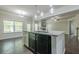 Kitchen island featuring a granite countertop, stainless steel dishwasher, and dark wood cabinetry at 207 Cherokee Reserve Cir, Canton, GA 30115