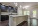 Stylish kitchen featuring granite countertops, dark cabinetry, and a central island, offering ample cooking space at 207 Cherokee Reserve Cir, Canton, GA 30115