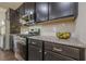 Close-up of a modern kitchen featuring stainless steel appliances and granite countertops at 207 Cherokee Reserve Cir, Canton, GA 30115