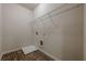 Bright laundry room with hardwood floors, overhead wire shelving, and a bright white interior at 207 Cherokee Reserve Cir, Canton, GA 30115