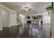 Open concept living room with hardwood floors, fireplace, staircase, and adjacent kitchen at 207 Cherokee Reserve Cir, Canton, GA 30115