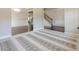 Open-concept living space with hardwood flooring, crown molding, and seamless flow into the dining area and staircase at 207 Cherokee Reserve Cir, Canton, GA 30115