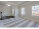 Inviting living room with large windows, neutral walls, and patterned rug, providing a bright and airy ambiance at 207 Cherokee Reserve Cir, Canton, GA 30115