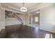 Bright living room with hardwood floors, crown molding, and an open layout to the staircase at 207 Cherokee Reserve Cir, Canton, GA 30115