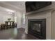 Inviting living room featuring a fireplace and seamless access to the dining area at 207 Cherokee Reserve Cir, Canton, GA 30115