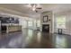 Spacious living room with hardwood floors, a fireplace, and an open view to the kitchen at 207 Cherokee Reserve Cir, Canton, GA 30115