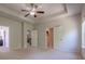 Spacious primary bedroom featuring tray ceilings, ceiling fan, and access to en suite bathroom at 207 Cherokee Reserve Cir, Canton, GA 30115