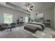 Bright main bedroom features a tray ceiling with fan, two large windows, and neutral walls at 207 Cherokee Reserve Cir, Canton, GA 30115