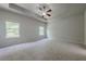 Large main bedroom with two windows, neutral walls and plush carpeting at 207 Cherokee Reserve Cir, Canton, GA 30115