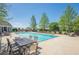 Sparkling community pool surrounded by lounging area and lush trees at 207 Cherokee Reserve Cir, Canton, GA 30115