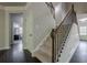 Staircase with carpeted steps, dark wood railing, and white trim leading to the upper level at 207 Cherokee Reserve Cir, Canton, GA 30115
