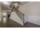 Elegant staircase with wood railing and carpeted steps ascending from hardwood flooring to the upper level at 207 Cherokee Reserve Cir, Canton, GA 30115