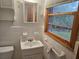 Bathroom with tiled walls, a window, a sink and a vanity at 2555 Angus Sw Ct, Marietta, GA 30008