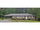 Charming one-story brick home with a covered carport and a well-manicured front lawn at 2555 Angus Sw Ct, Marietta, GA 30008
