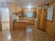 Vintage-style kitchen with wooden cabinets, laminate countertops, breakfast bar, and tiled floors at 2555 Angus Sw Ct, Marietta, GA 30008