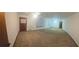 Spacious living room featuring neutral carpet, light fixtures, and ample natural light from the windows at 2555 Angus Sw Ct, Marietta, GA 30008