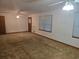 Spacious living room featuring neutral carpet, light fixtures, and ample natural light from the windows at 2555 Angus Sw Ct, Marietta, GA 30008