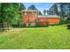 View of the backyard showcasing the house's rear exterior and a large grassy lawn at 3955 Old Fairburn Sw Rd, Atlanta, GA 30331