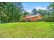 Spacious backyard with green grass, a wooden fence, and mature trees providing privacy at 3955 Old Fairburn Sw Rd, Atlanta, GA 30331