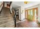 Welcoming foyer featuring a unique stone floor, staircase, and stained glass front door at 3955 Old Fairburn Sw Rd, Atlanta, GA 30331