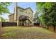 Backyard with deck, mature trees, and a wood privacy fence at 4560 Weathervane Dr, Alpharetta, GA 30022