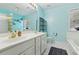 Bright bathroom with double sinks, vanity, bathtub, shower with glass block, and ample counter space at 4560 Weathervane Dr, Alpharetta, GA 30022