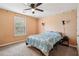 Bedroom featuring a ceiling fan and patterned bedding with natural light from a window at 4560 Weathervane Dr, Alpharetta, GA 30022