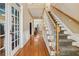 Bright foyer with hardwood floors, staircase, and French doors, creating an inviting entrance at 4560 Weathervane Dr, Alpharetta, GA 30022