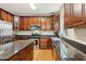 Well-equipped kitchen with rich wood cabinets, granite countertops, and stainless steel appliances at 4560 Weathervane Dr, Alpharetta, GA 30022