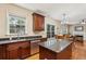 Bright kitchen featuring granite counters, stainless steel appliances, island, and adjacent dining area at 4560 Weathervane Dr, Alpharetta, GA 30022