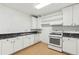 Kitchen featuring white cabinets, a tiled floor, and modern appliances at 4560 Weathervane Dr, Alpharetta, GA 30022