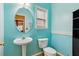 This powder room features a pedestal sink, white toilet, and light blue walls at 4560 Weathervane Dr, Alpharetta, GA 30022