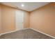 Room showcasing neutral carpet, peach colored walls, and a white door with trim at 4560 Weathervane Dr, Alpharetta, GA 30022