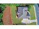Aerial view of roof with deck and retaining wall near manicured lawn at 1168 Woodtrace Ln, Auburn, GA 30011