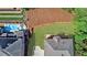 Aerial view of backyard with pool, deck, and retaining wall near manicured lawn at 1168 Woodtrace Ln, Auburn, GA 30011