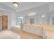 Bathroom with a soaking tub, separate shower, double vanity, and neutral tile at 1168 Woodtrace Ln, Auburn, GA 30011