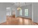Bright dining room with hardwood floors, coffered ceiling, and elegant chandelier at 1168 Woodtrace Ln, Auburn, GA 30011
