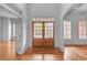 Bright foyer with high ceilings, wood floors, and a beautiful double-door entrance at 1168 Woodtrace Ln, Auburn, GA 30011