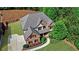 Charming brick home featuring a well-manicured lawn, mature trees, and a long driveway at 1168 Woodtrace Ln, Auburn, GA 30011