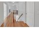 Bright hallway boasts hardwood floors, neutral paint, and leads to upstairs landing at 1168 Woodtrace Ln, Auburn, GA 30011
