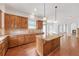 Elegant kitchen with granite counters, custom island and hardwood floors at 1168 Woodtrace Ln, Auburn, GA 30011
