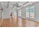 Open living room featuring coffered ceiling, large windows, and hardwood flooring at 1168 Woodtrace Ln, Auburn, GA 30011