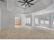 Spacious main bedroom features a tray ceiling with fan and a bank of windows at 1168 Woodtrace Ln, Auburn, GA 30011