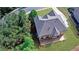 Aerial view of home's backyard featuring an expansive deck, grassy area, and mature trees at 1168 Woodtrace Ln, Auburn, GA 30011
