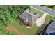 Aerial view of home's backyard featuring an expansive deck, grassy area, and mature trees at 1168 Woodtrace Ln, Auburn, GA 30011