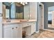 Double sink bathroom vanity with hard surface countertops and bronze fixtures at 1719 Kings Cross Ct, Hoschton, GA 30548