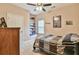 Cozy bedroom with neutral walls, ceiling fan, carpet, and window seat nook at 1719 Kings Cross Ct, Hoschton, GA 30548