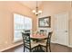Cozy dining room featuring a round wood table and natural light at 1719 Kings Cross Ct, Hoschton, GA 30548