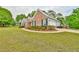 Well-maintained home exterior with manicured lawn and attached garage at 1719 Kings Cross Ct, Hoschton, GA 30548